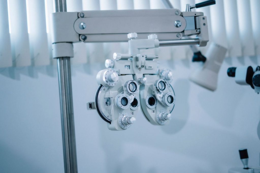 Detailed view of an optical phoropter in a modern eye clinic, used for testing vision clarity.