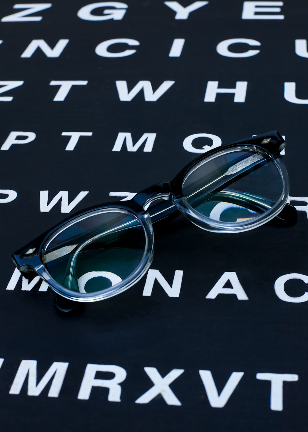 The image features a pair of eyeglasses placed on an eye chart, symbolizing the importance of vision care and regular eye exams. The eye chart represents the standard tool used by optometrists to assess visual acuity, while the glasses emphasize the need for corrective lenses for those with impaired vision. This image serves as a reminder to prioritize eye health, undergo routine check-ups, and ensure proper vision correction to maintain overall well-being.